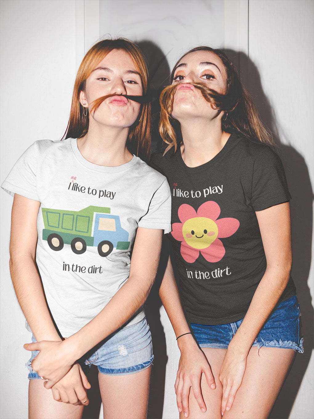 2 friends wearing similar shirt joking around - still like to play I the dirt