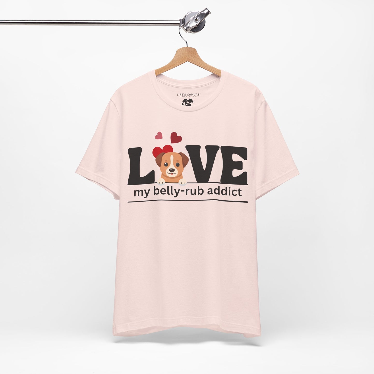 “LOVE My Belly-Rub Addict” t-shirt with puppy peeking out, on a hanger in Soft Pink