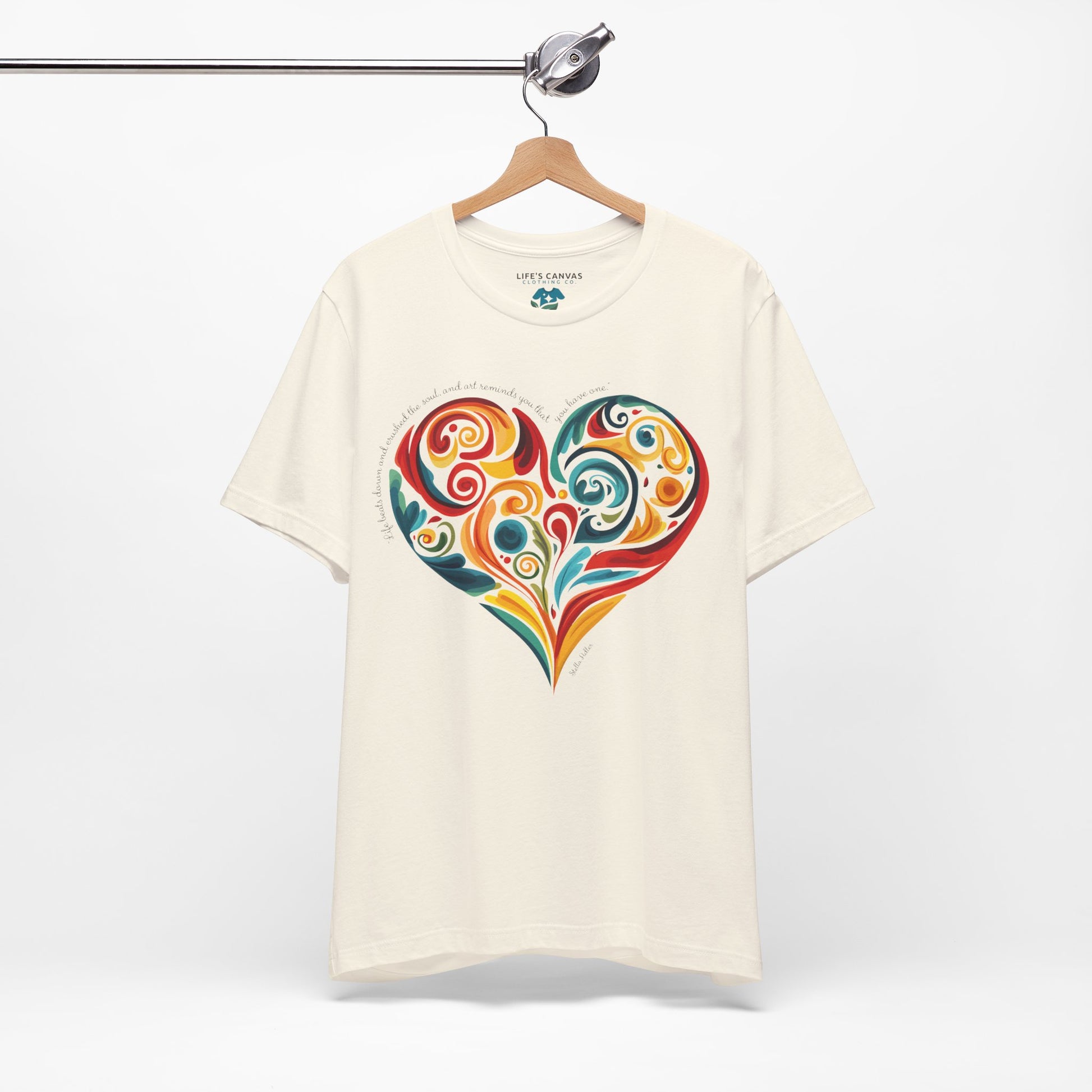Unisex t-shirt with Stella Adler quote and heart swirl design on hanger- Natural