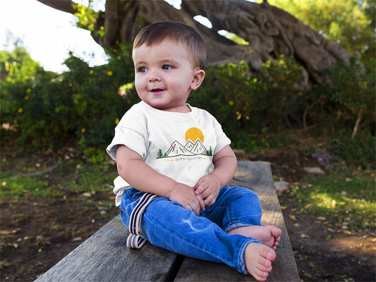 Baby wearing “Born to Roam” shirt outdoors