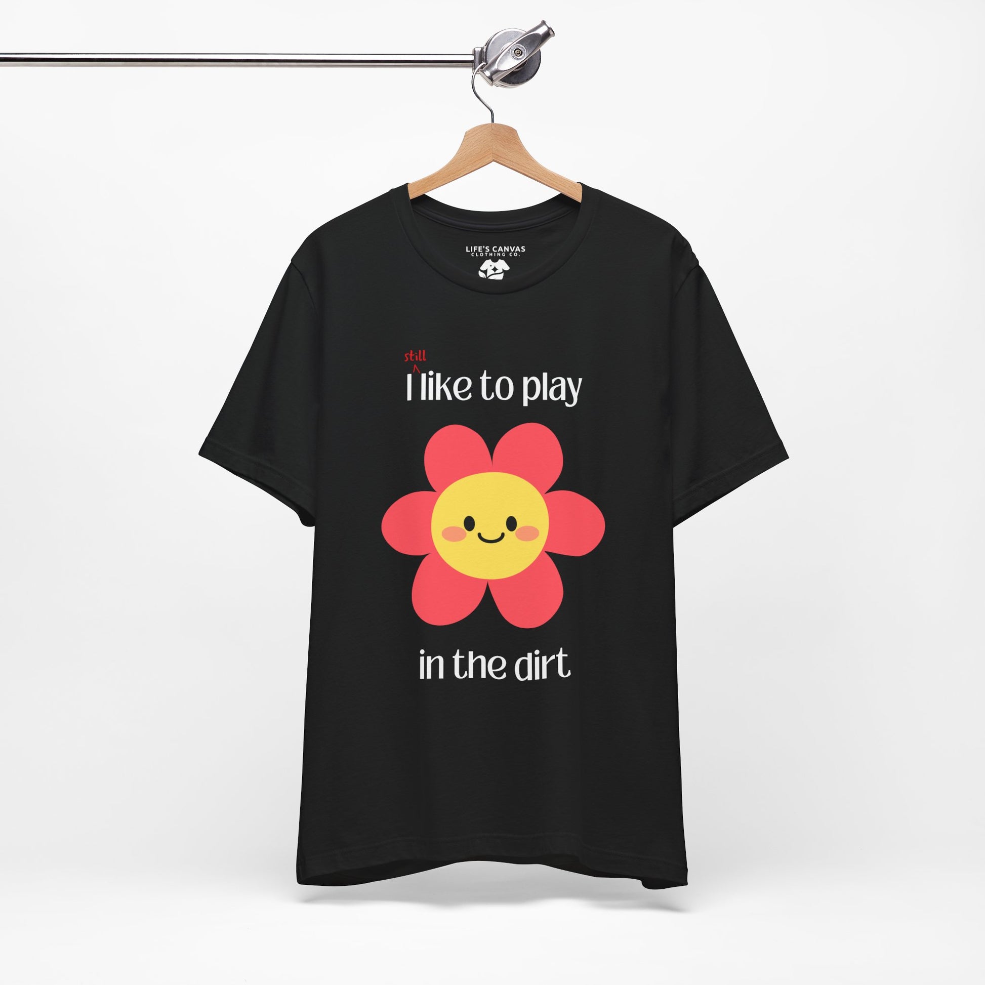 Black t-shirt on a hanger with a  pink flower- I still like to play in the dirt