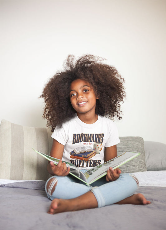 “Bookmarks Are for Quitters” shirt worn by child reading - White