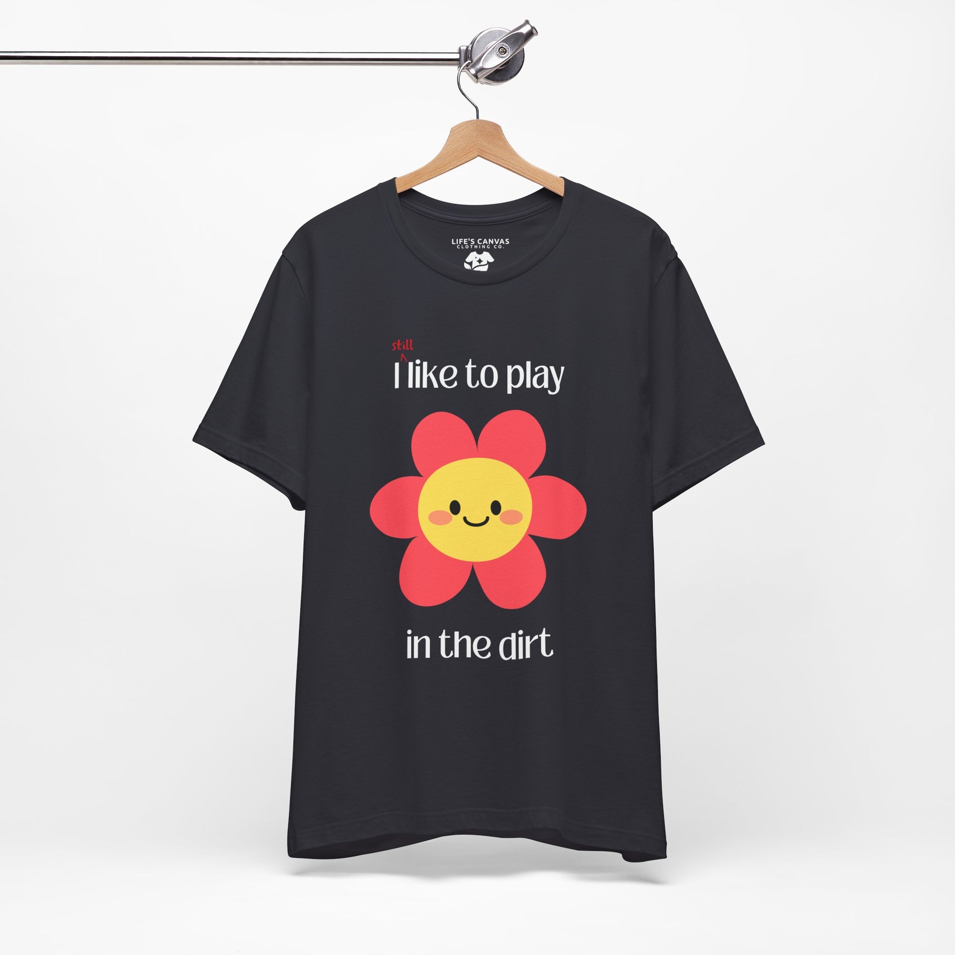 Dark grey t-shirt on a hanger with a  pink flower- I still like to play in the dirt