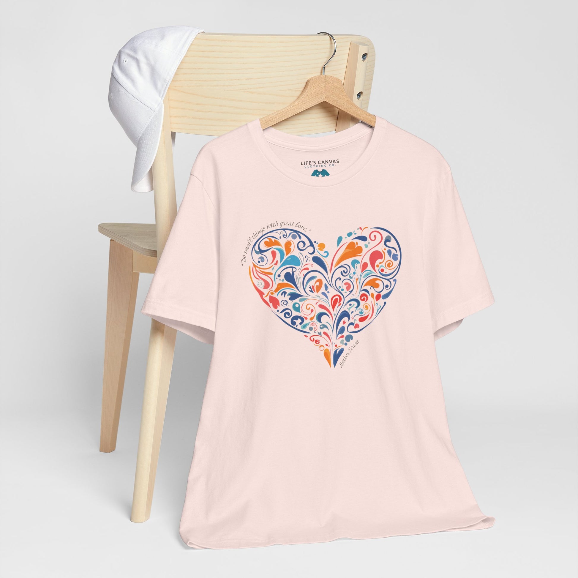 Kindness quote tee inspired by Mother Teresa hanging off a chair- Soft Pink
