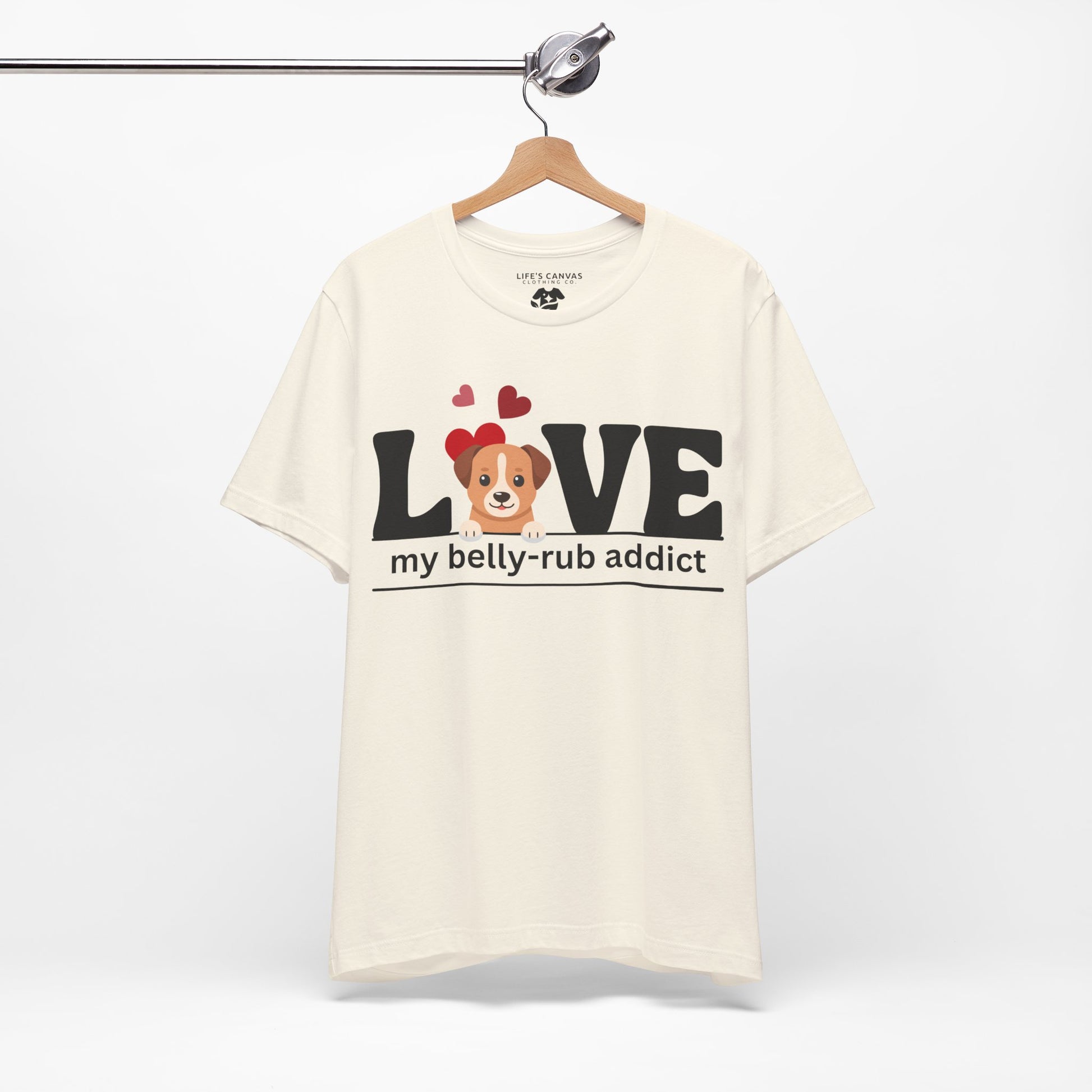“LOVE My Belly-Rub Addict” t-shirt with puppy peeking out, on a hanger  in Natural