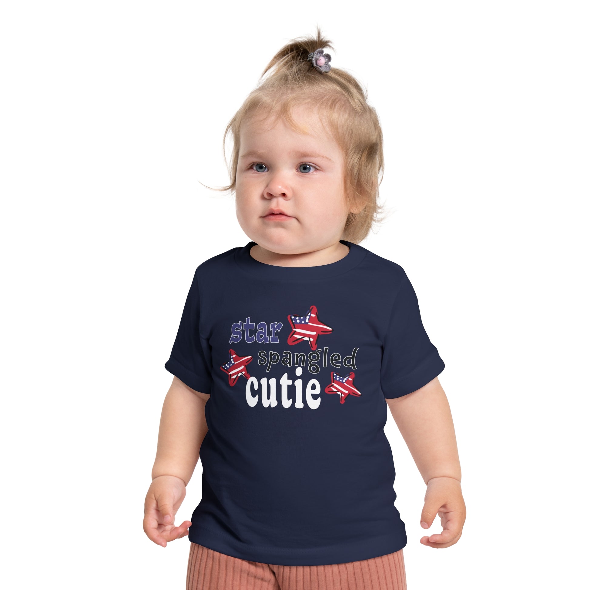 Baby wearing a navy t-shrit with typography and patriotic stars, t-shirt says "star spangled cutie"