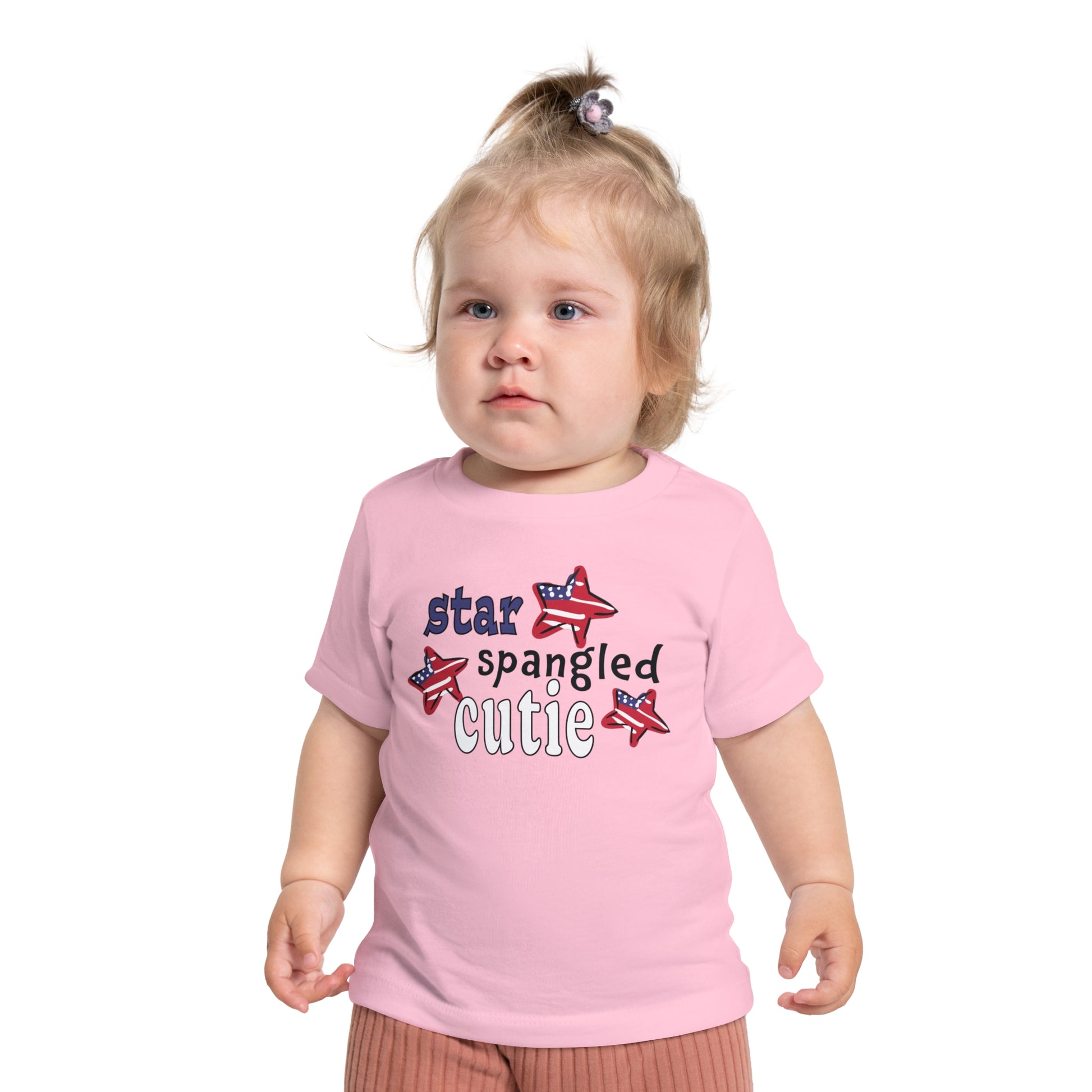 Baby wearing a pink t-shrit with typography and patriotic stars, t-shirt says "star spangled cutie"