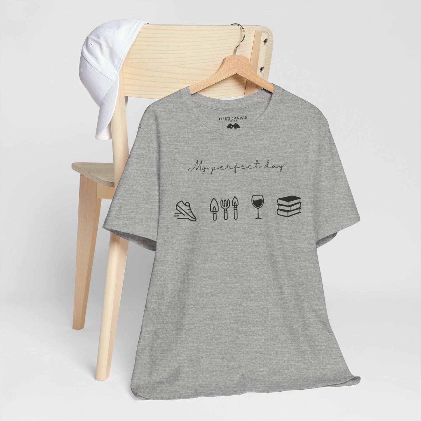 Unisex shirt with jog, garden, wine, and book icons on a hanger in athletic heather