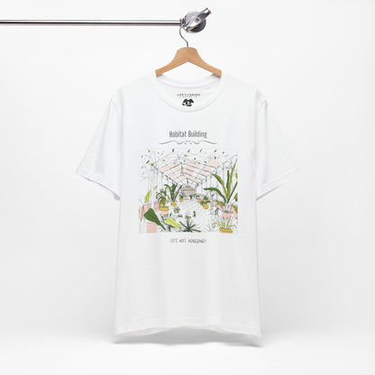 Unisex plant lover shirt that says “Habitat Building, It’s Not Hoarding” on a hanger in White