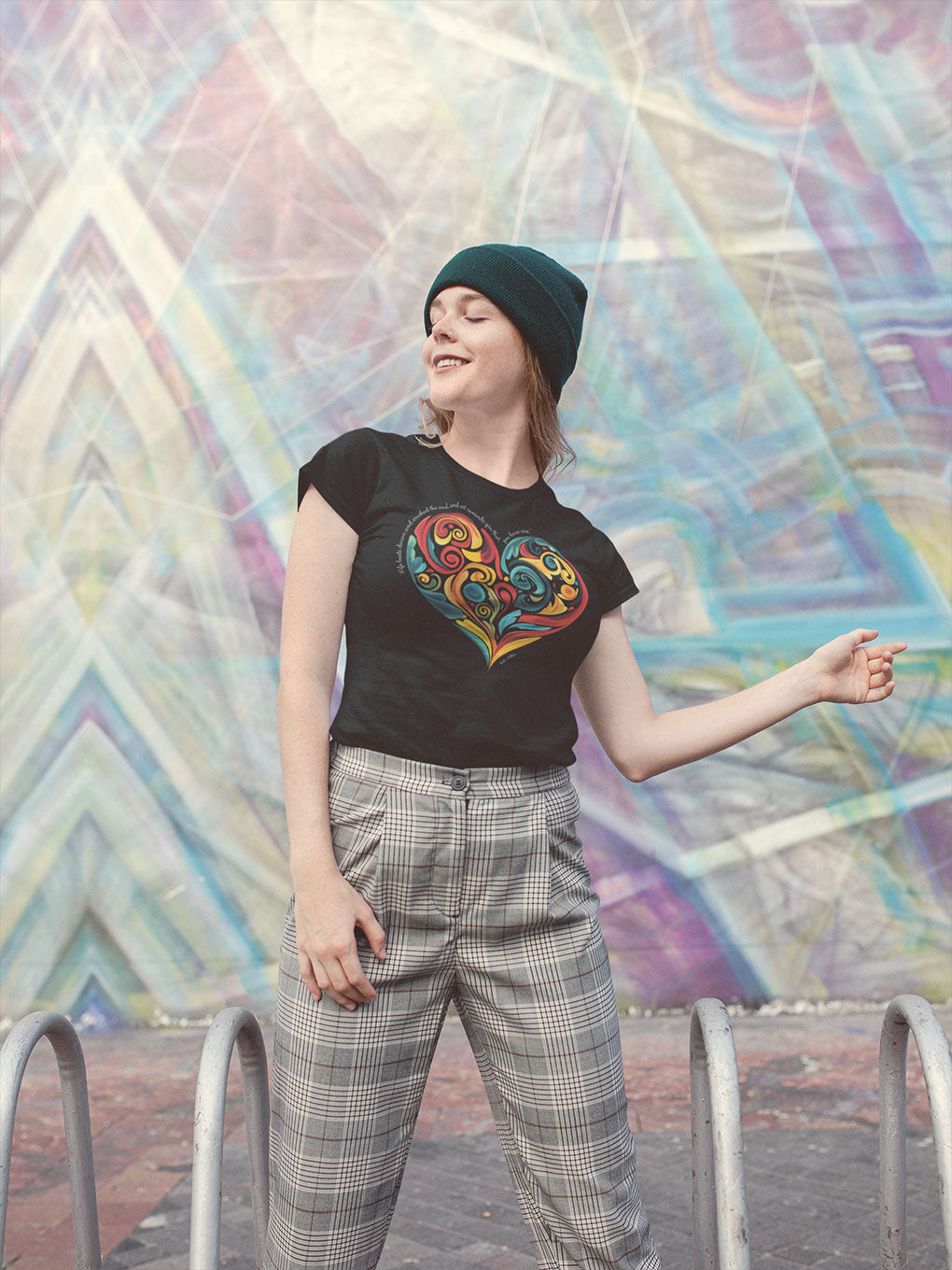 Creative woman eyes closed taking in the moment outside while wearing Stella Adler quote and heart swirl design  t-shirt