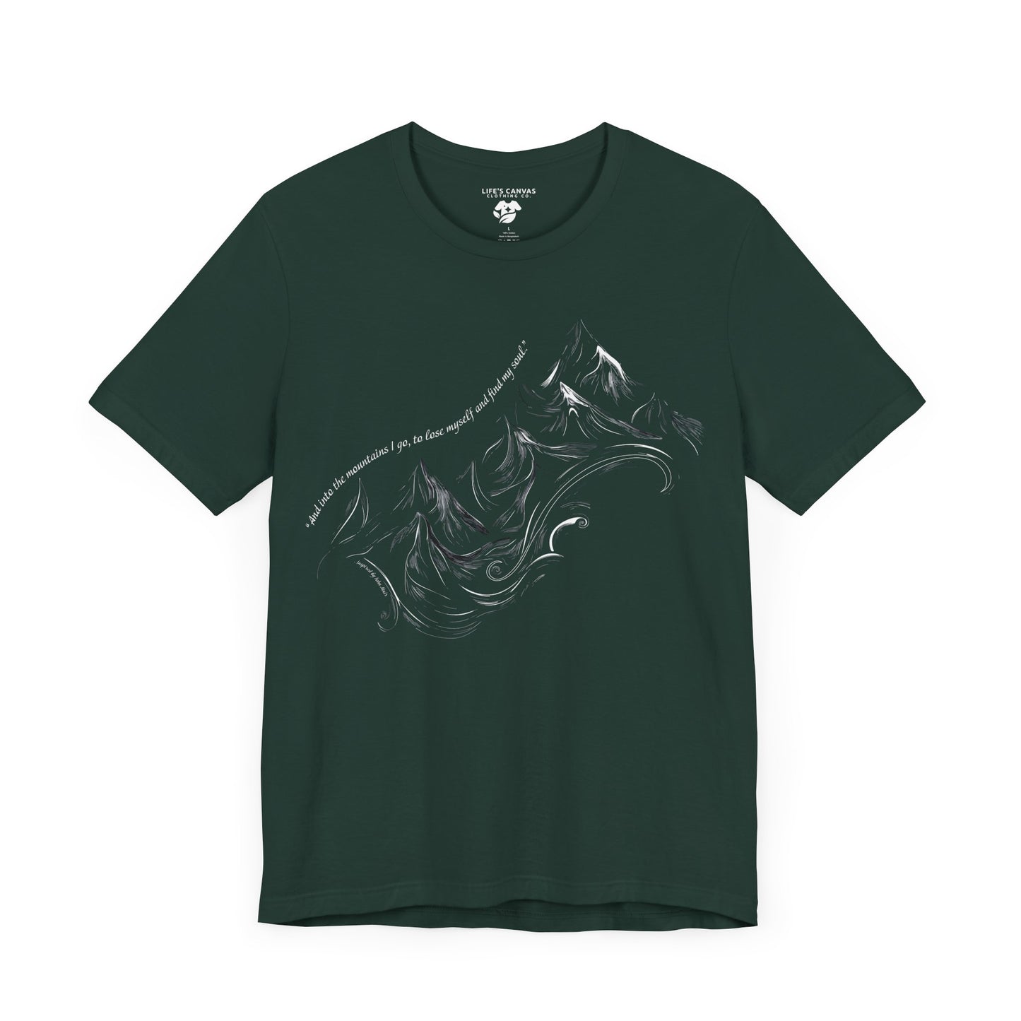 Unisex t-shirt with sketched mountain design and John Muir quote “Into the Mountains I go...”- Forest laying flat
