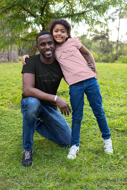 Youth wearing "wander and Wonder" minimalist mountain design t-shirt with parent
