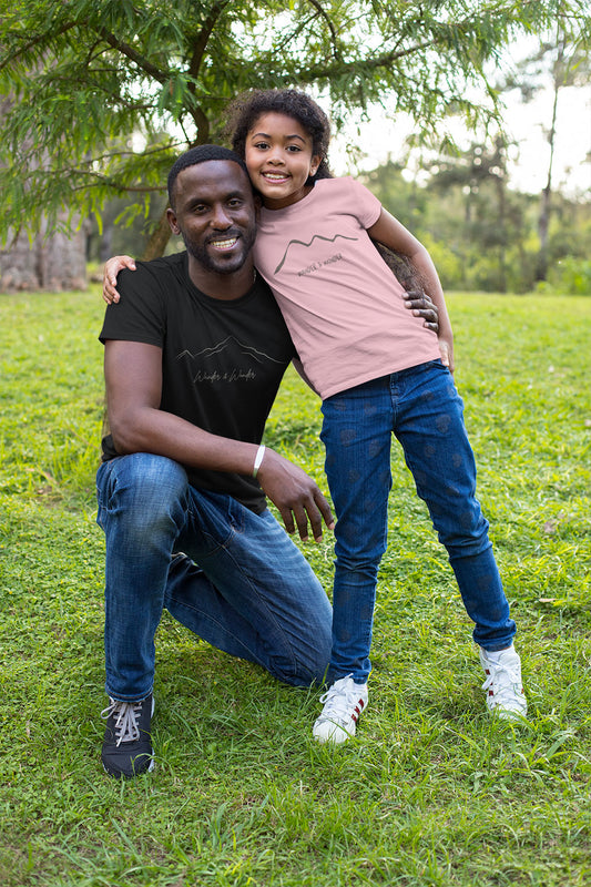 Youth wearing "wander and Wonder" minimalist mountain design t-shirt with parent