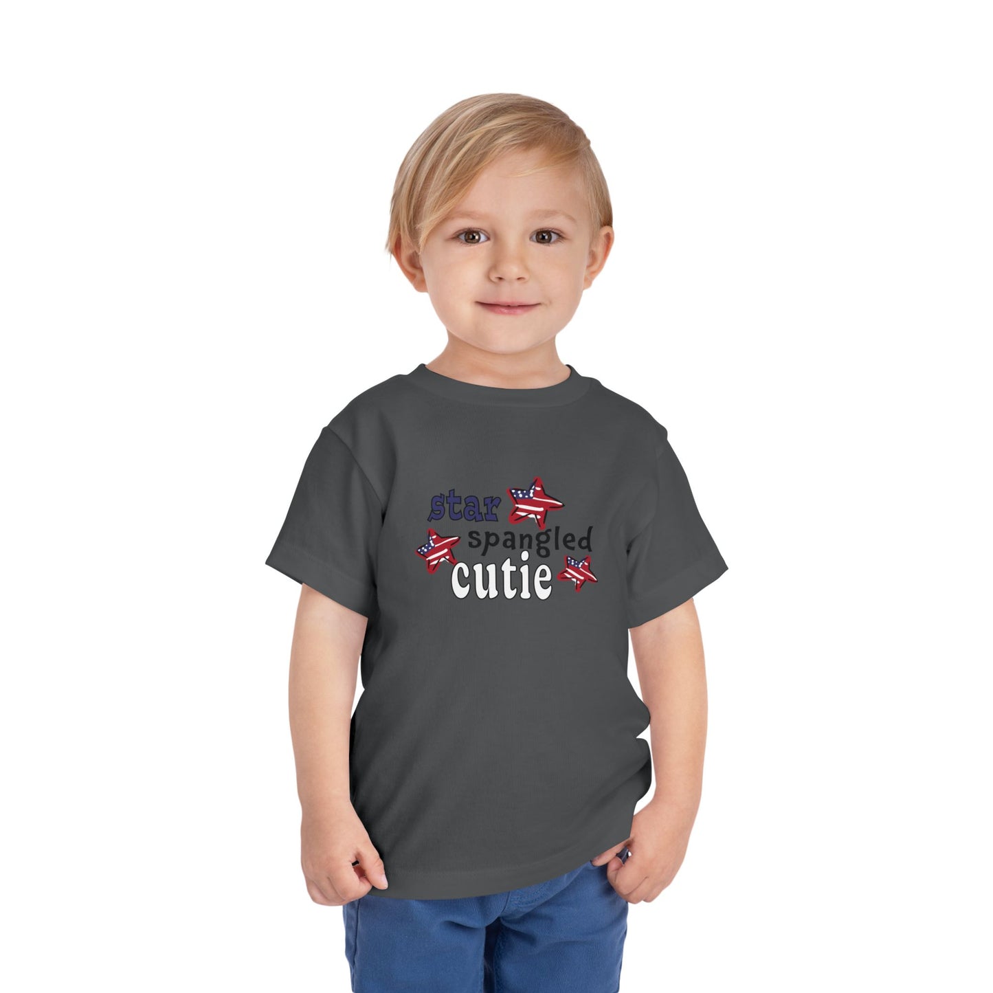 Asphalt toddler t-shrit on a model with typography and patriotic stars, t-shirt says "star spangled cutie"