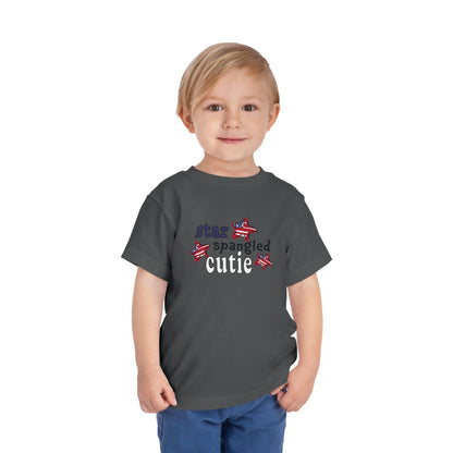 Asphalt toddler t-shrit on a model with typography and patriotic stars, t-shirt says "star spangled cutie"