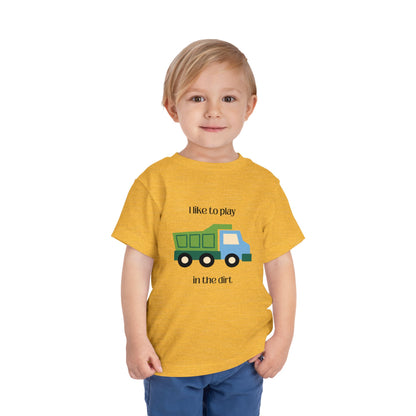 model wearing I Like to  play in dirt truck- toddler tee -Heather Yellow Gold