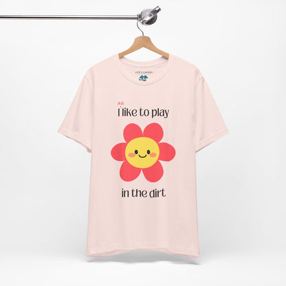 soft pink t-shirt on a hanger with a  pink flower- I still like to play in the dirt