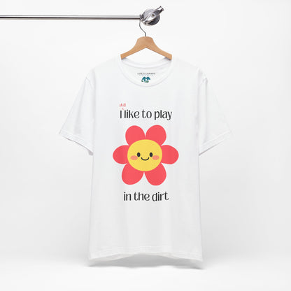 white t-shirt on a hanger with a  pink flower- I still like to play in the dirt